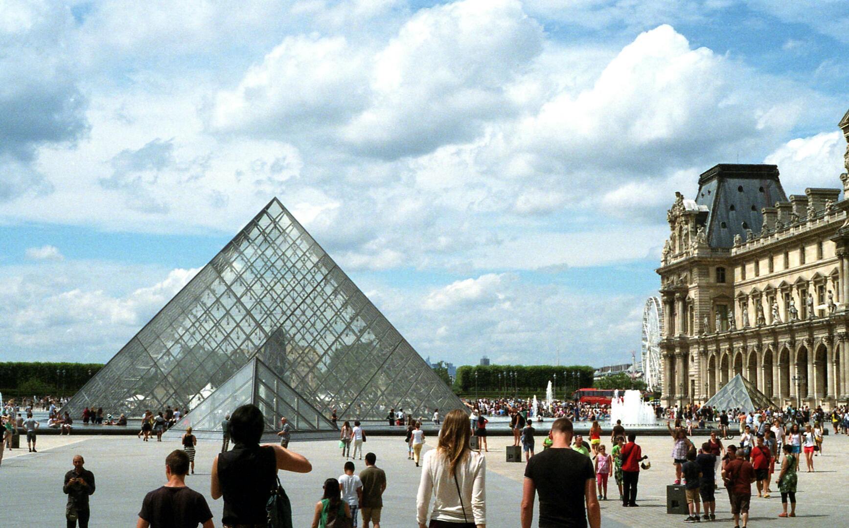 The Louvre Museum with its iconic glass pyramid in the Cour Napoléon