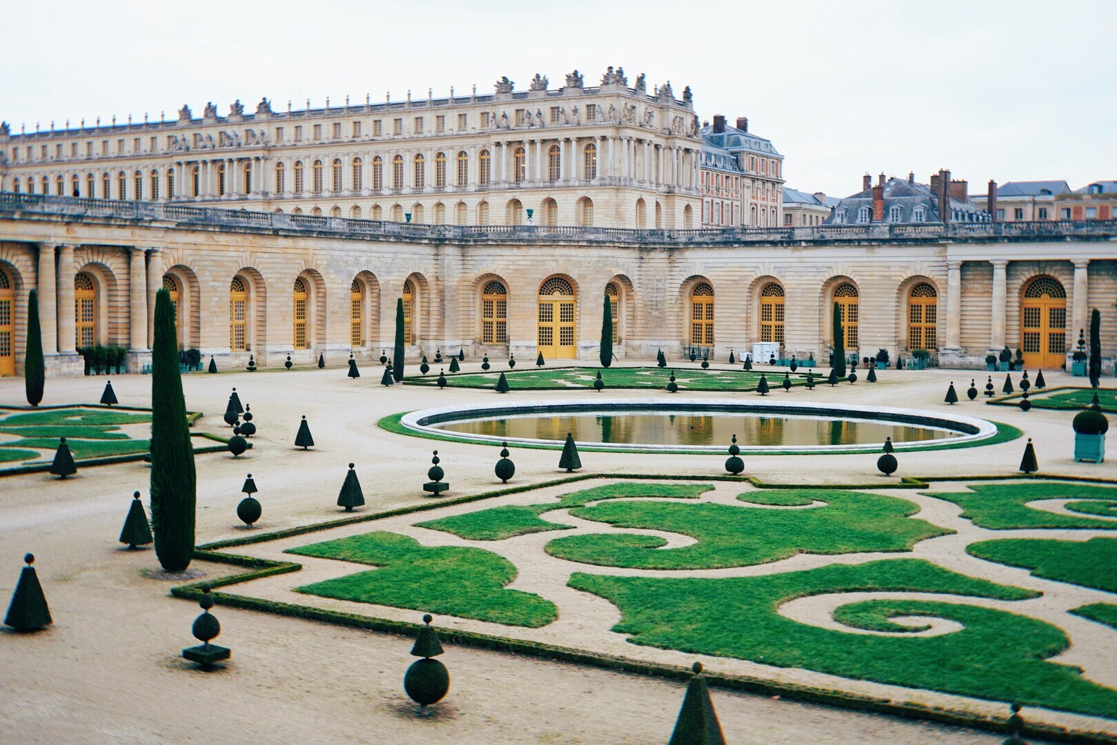 The formal gardens of Versailles with geometric parterres and fountains